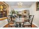 Elegant dining room with hardwood floors, a chandelier, and an open view into the living room and kitchen at 2925 S Vaughn Way, Aurora, CO 80014