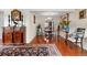 Charming dining area features hardwood floors, a round table, and a view into the living room and kitchen at 2925 S Vaughn Way, Aurora, CO 80014