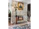 Close up view of fireplace area shows stacked stone, gas insert, mantle and decor at 2925 S Vaughn Way, Aurora, CO 80014