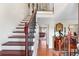 Elegant foyer features a staircase with hardwood steps, wrought iron railing, and decor that exudes refined taste at 2925 S Vaughn Way, Aurora, CO 80014