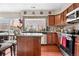 This kitchen features wood cabinets, an island, and a garden window over the sink at 2925 S Vaughn Way, Aurora, CO 80014