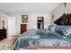 Main bedroom featuring an ornate headboard, closet, and dresser at 2925 S Vaughn Way, Aurora, CO 80014