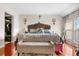 Spacious main bedroom with hardwood floors and a large decorative headboard at 2925 S Vaughn Way, Aurora, CO 80014