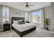 Well-lit bedroom featuring a queen-sized bed, decorative accents, and large windows at 23615 E 5Th Pl, Aurora, CO 80018