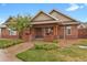 Community clubhouse features brick and siding exterior, covered porch, and manicured landscaping at 23615 E 5Th Pl, Aurora, CO 80018