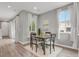 Dining area features a table set and natural light from the windows with decorative curtains at 23615 E 5Th Pl, Aurora, CO 80018
