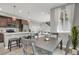 Bright dining area with a modern table set, pendant lights, and views into the kitchen and living space at 23615 E 5Th Pl, Aurora, CO 80018