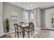 Sunlit dining area with table set, complemented by light grey wall paint and bright white curtains at 23615 E 5Th Pl, Aurora, CO 80018