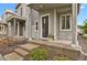 Inviting front entrance of a two-story home featuring stone accents, and a well-kept lawn and garden at 23615 E 5Th Pl, Aurora, CO 80018