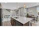 Open kitchen boasts a spacious center island with sink, pendant lights and dining area, with views of living area at 23615 E 5Th Pl, Aurora, CO 80018