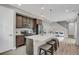 Modern kitchen features a center island with bar stool seating, stainless steel appliances, and pendant lighting at 23615 E 5Th Pl, Aurora, CO 80018