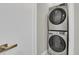 Close up of a stacked washer and dryer set with stylish floor tiles in laundry room at 23615 E 5Th Pl, Aurora, CO 80018