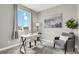 Bright home office with a stylish desk, comfortable seating, and a large window at 23615 E 5Th Pl, Aurora, CO 80018