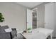 Modern office space featuring a decorative plant, open door, and a comfortable armchair at 23615 E 5Th Pl, Aurora, CO 80018