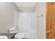 Bathroom featuring a shower over tub and a tiled shower wall at 5857 S Zante Cir, Aurora, CO 80015