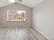 Light-filled bedroom with vaulted ceiling, modern gray flooring and large picture window at 5857 S Zante Cir, Aurora, CO 80015