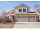 Charming two-story home featuring a three-car garage and neutral-colored siding, enhancing its curb appeal at 5857 S Zante Cir, Aurora, CO 80015