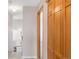 Well-lit hallway showcasing wooden doors and views of the home's interior at 5857 S Zante Cir, Aurora, CO 80015