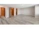 Expansive living room with wood-look floors and multiple doorways at 5857 S Zante Cir, Aurora, CO 80015