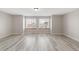 Spacious living room with natural light and modern gray flooring at 5857 S Zante Cir, Aurora, CO 80015