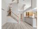 Open-concept living area showcasing the staircase, kitchen, and dining spaces with modern finishes at 5857 S Zante Cir, Aurora, CO 80015