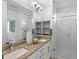 Bathroom featuring granite countertops, double sinks, and a glass-enclosed shower at 11719 W 45Th Pl, Wheat Ridge, CO 80033