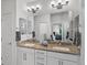 Modern bathroom with granite countertops, double sinks, and a large mirror at 11719 W 45Th Pl, Wheat Ridge, CO 80033
