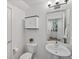 Charming half bathroom features a modern pedestal sink and decorative cabinet at 11719 W 45Th Pl, Wheat Ridge, CO 80033