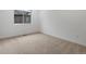 Cozy carpeted bedroom, featuring a large window that provides plenty of natural light at 11719 W 45Th Pl, Wheat Ridge, CO 80033