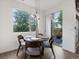 Bright dining area with a modern chandelier and sliding glass door access to the patio at 11719 W 45Th Pl, Wheat Ridge, CO 80033