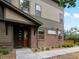 Attractive home exterior with brick and siding, featuring a covered porch and landscaped yard at 11719 W 45Th Pl, Wheat Ridge, CO 80033