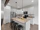 Modern kitchen with granite countertops, stainless steel appliances, and a spacious island with seating at 11719 W 45Th Pl, Wheat Ridge, CO 80033