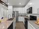 Modern kitchen features stainless steel appliances, granite countertops, and white cabinets at 11719 W 45Th Pl, Wheat Ridge, CO 80033