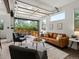 Open living space featuring garage-style door to outdoor seating, modern furniture, and sleek design at 11719 W 45Th Pl, Wheat Ridge, CO 80033
