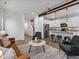 Open-concept living area connecting to a modern kitchen, showcasing a functional and stylish living space at 11719 W 45Th Pl, Wheat Ridge, CO 80033