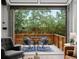 Living room with indoor/outdoor space, open to the patio through a garage door-style window and seating at 11719 W 45Th Pl, Wheat Ridge, CO 80033