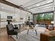Bright living room with modern kitchen, garage door-style opening to a patio, and contemporary furnishings at 11719 W 45Th Pl, Wheat Ridge, CO 80033