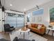Cozy living room featuring garage door-style window, modern furniture, and abundant natural light at 11719 W 45Th Pl, Wheat Ridge, CO 80033