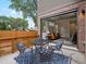 Cozy outdoor patio with seating, a brick accent wall, and indoor/outdoor living at 11719 W 45Th Pl, Wheat Ridge, CO 80033