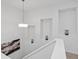 Bright stairwell features decorative wall cutouts, a modern chandelier, and artistic decor at 11719 W 45Th Pl, Wheat Ridge, CO 80033