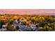 An aerial shot of a neighborhood with lush trees and distant mountains at 10157 W 38Th Ave, Wheat Ridge, CO 80033