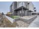 Backyard with small outdoor patio, rock garden, and artificial grass at 10157 W 38Th Ave, Wheat Ridge, CO 80033