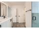 Bathroom featuring a double vanity, glass shower, and sleek black hardware at 10157 W 38Th Ave, Wheat Ridge, CO 80033