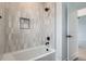 Modern bathroom showcasing a bathtub with tiled walls and black fixtures at 10157 W 38Th Ave, Wheat Ridge, CO 80033