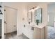 Bright bathroom featuring double vanity with modern black fixtures and tiled floors at 10157 W 38Th Ave, Wheat Ridge, CO 80033