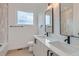 Bright bathroom featuring a double vanity, window, and bathtub with tiled surround at 10157 W 38Th Ave, Wheat Ridge, CO 80033