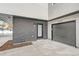 Attached garage and entry of a modern home featuring a sleek gray door at 10157 W 38Th Ave, Wheat Ridge, CO 80033