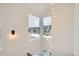 A view looking down an open stairwell with a long drop light fixture and side windows at 10157 W 38Th Ave, Wheat Ridge, CO 80033