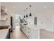 Contemporary kitchen with stainless appliances, island, and open layout to staircase at 10157 W 38Th Ave, Wheat Ridge, CO 80033