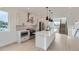 Bright modern kitchen boasts stainless steel appliances, an island, and sleek minimalist finishes at 10157 W 38Th Ave, Wheat Ridge, CO 80033